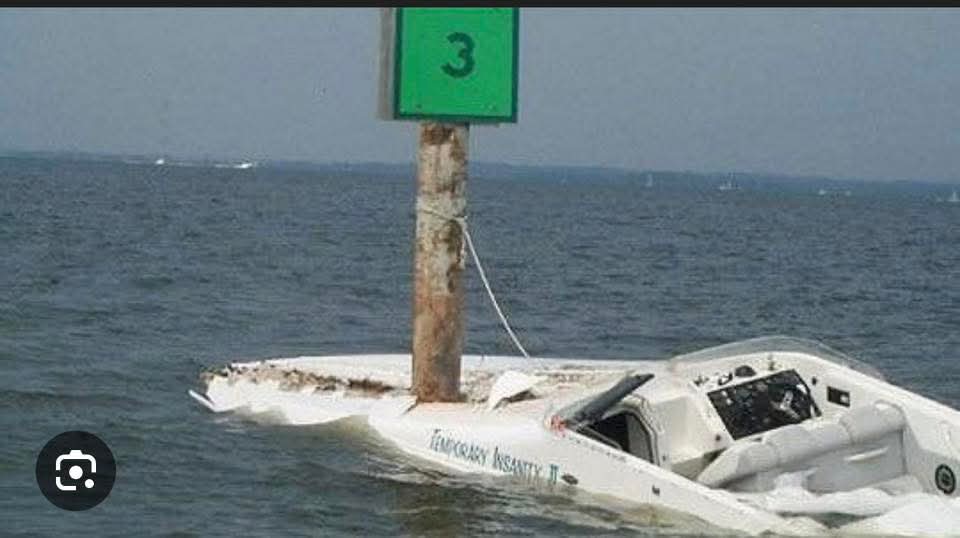 Boat grounded on a channel marker after a nighttime collision
